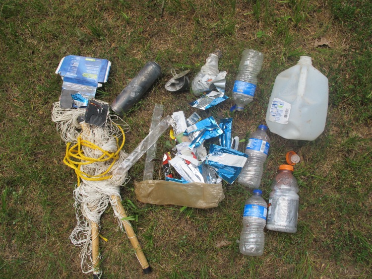 Some of the trash collected at the site.  Notice the burned aerosol can. 