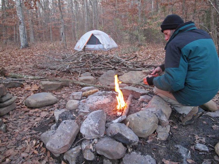 Bob building a fire at the west crossing of Hurricane Creek.