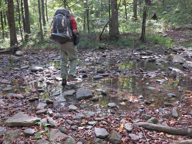 Bob stepping across Spirits Creek. 