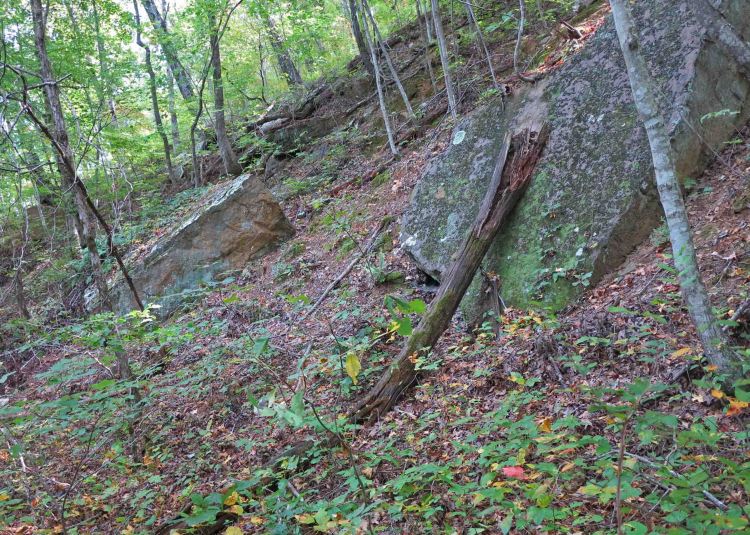Bolders sliding down the sides of the old excavation for the railroad bed. 