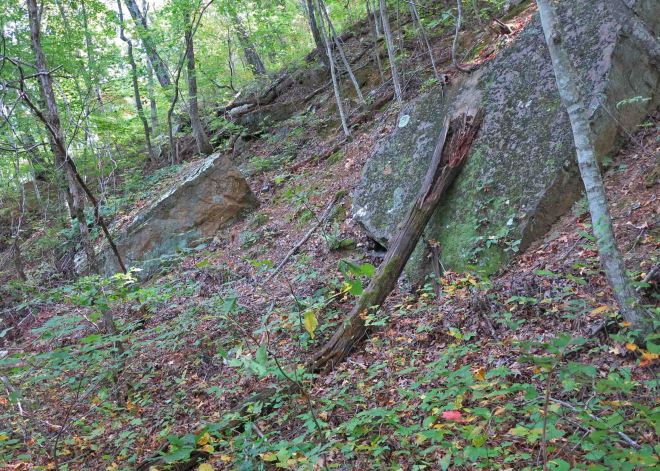Bolders sliding down the sides of the old excavation for the railroad bed. 