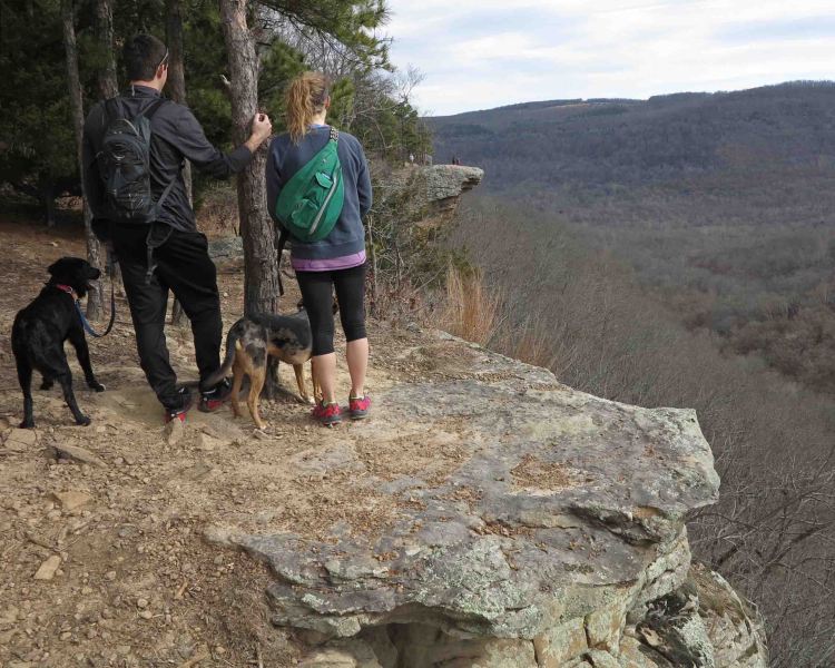 A couple looking at Hawksbill Crag in the distance.