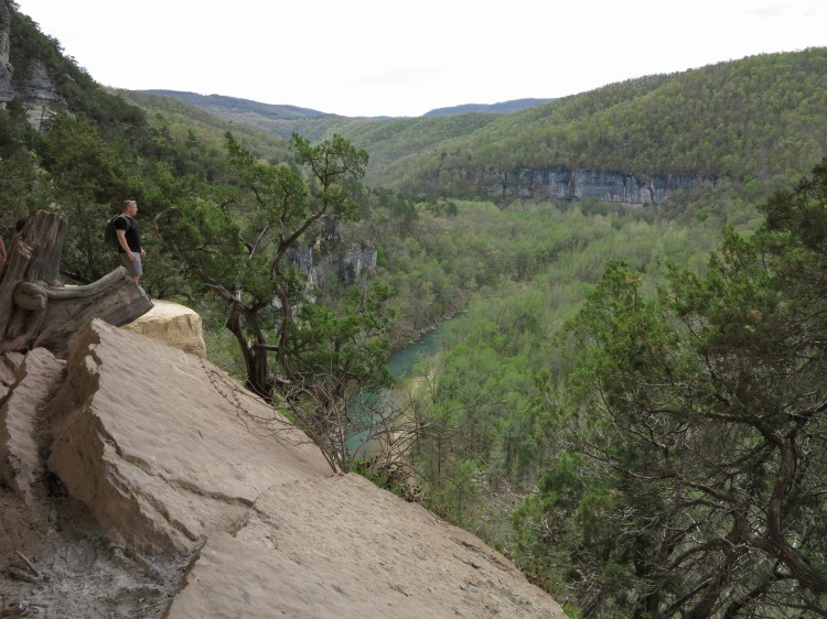 Hiker on Goat Bluff looking down on the Buffalo River